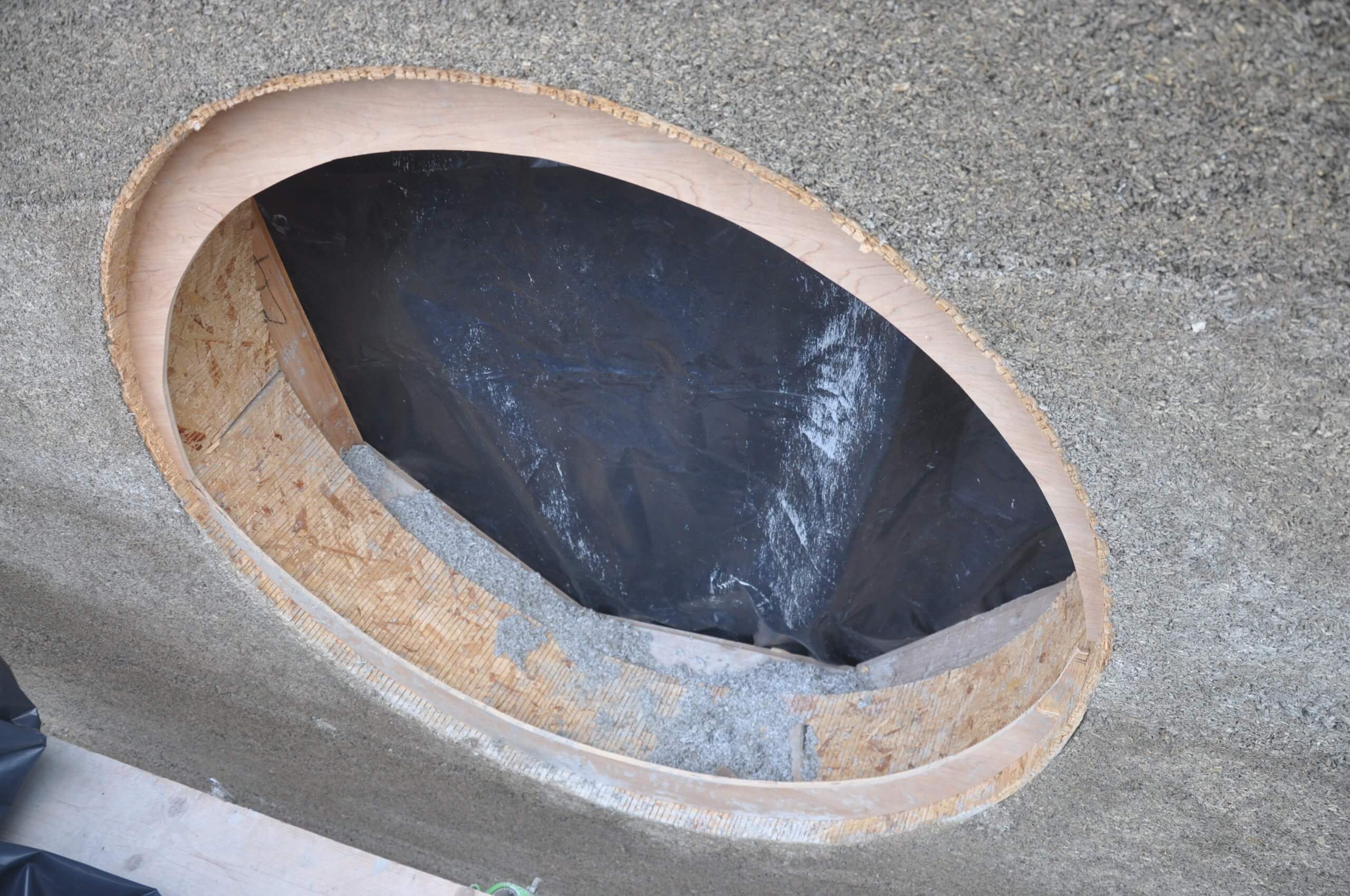 OSB shuttering forming a round opening in a cast hempcrete wall