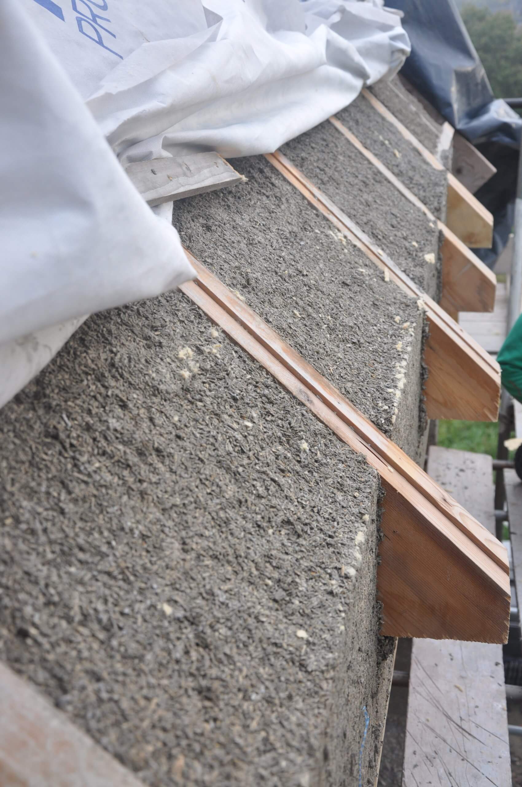 hempcrete wall extending to the top of roof rafters with temporary roof covering