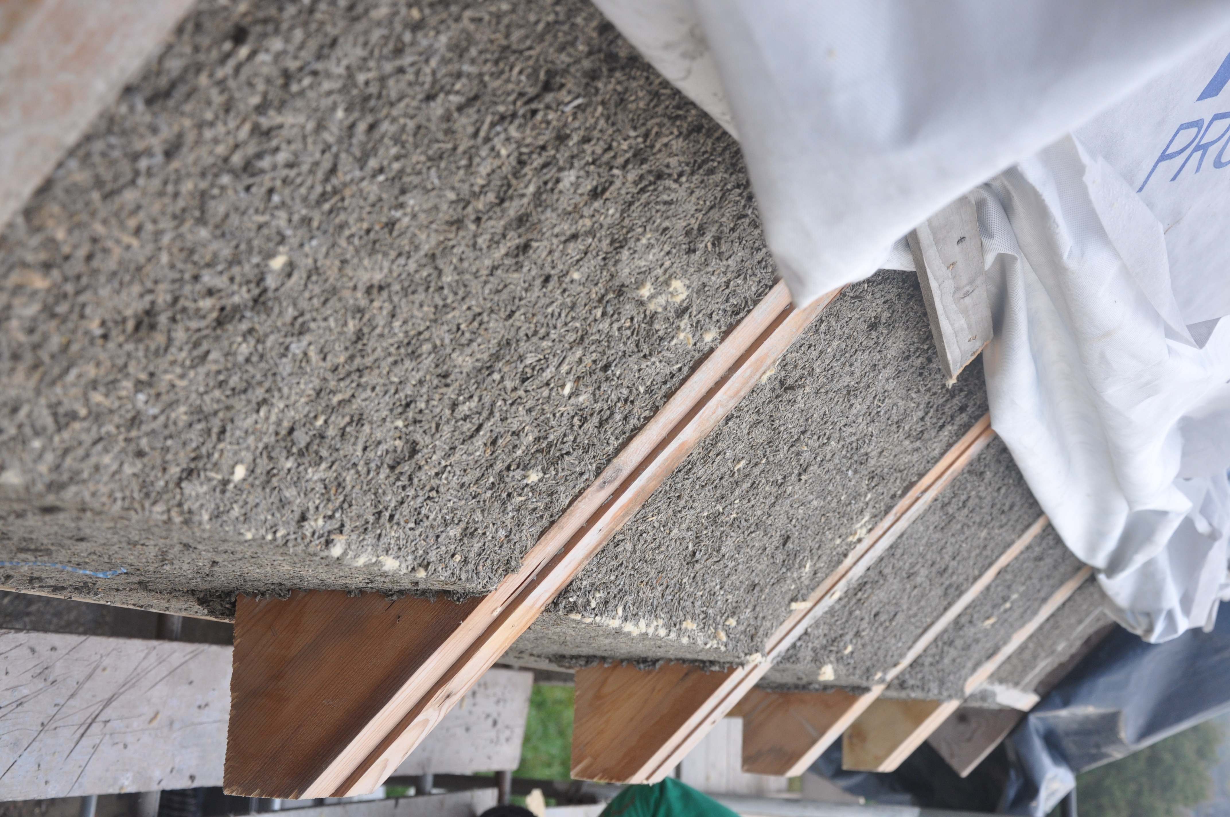 hempcrete wall extending to the top of roof rafters with temporary roof covering