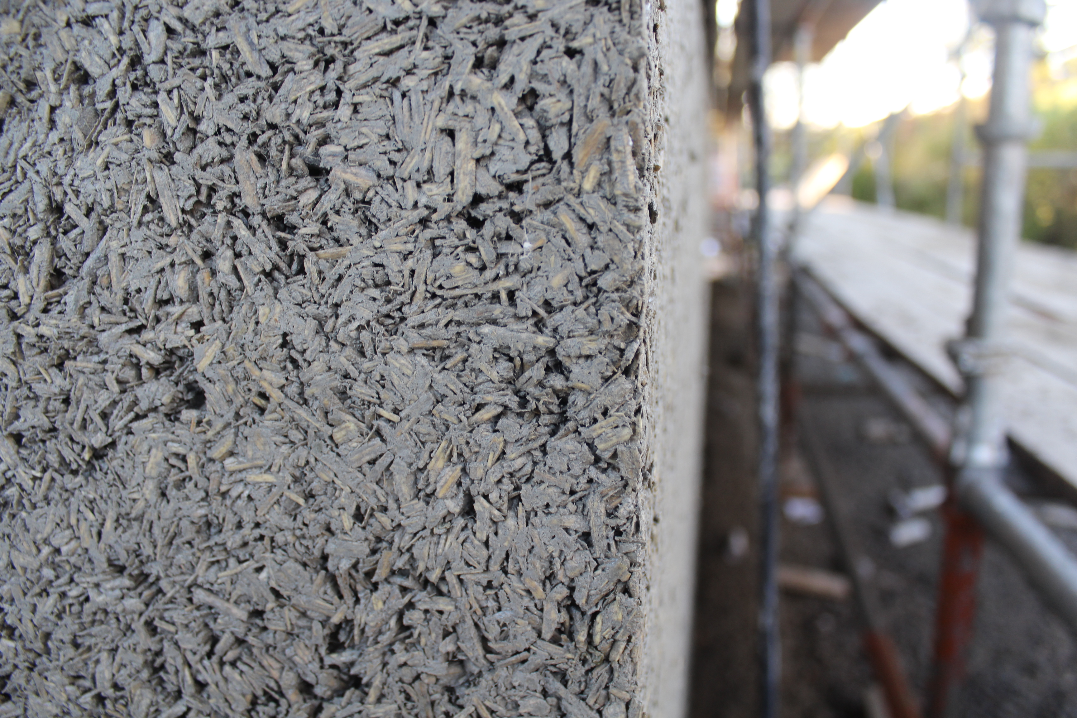 close up of cast on site hempcrete showing the mixture of hemp shiv and hydraulic lime binder