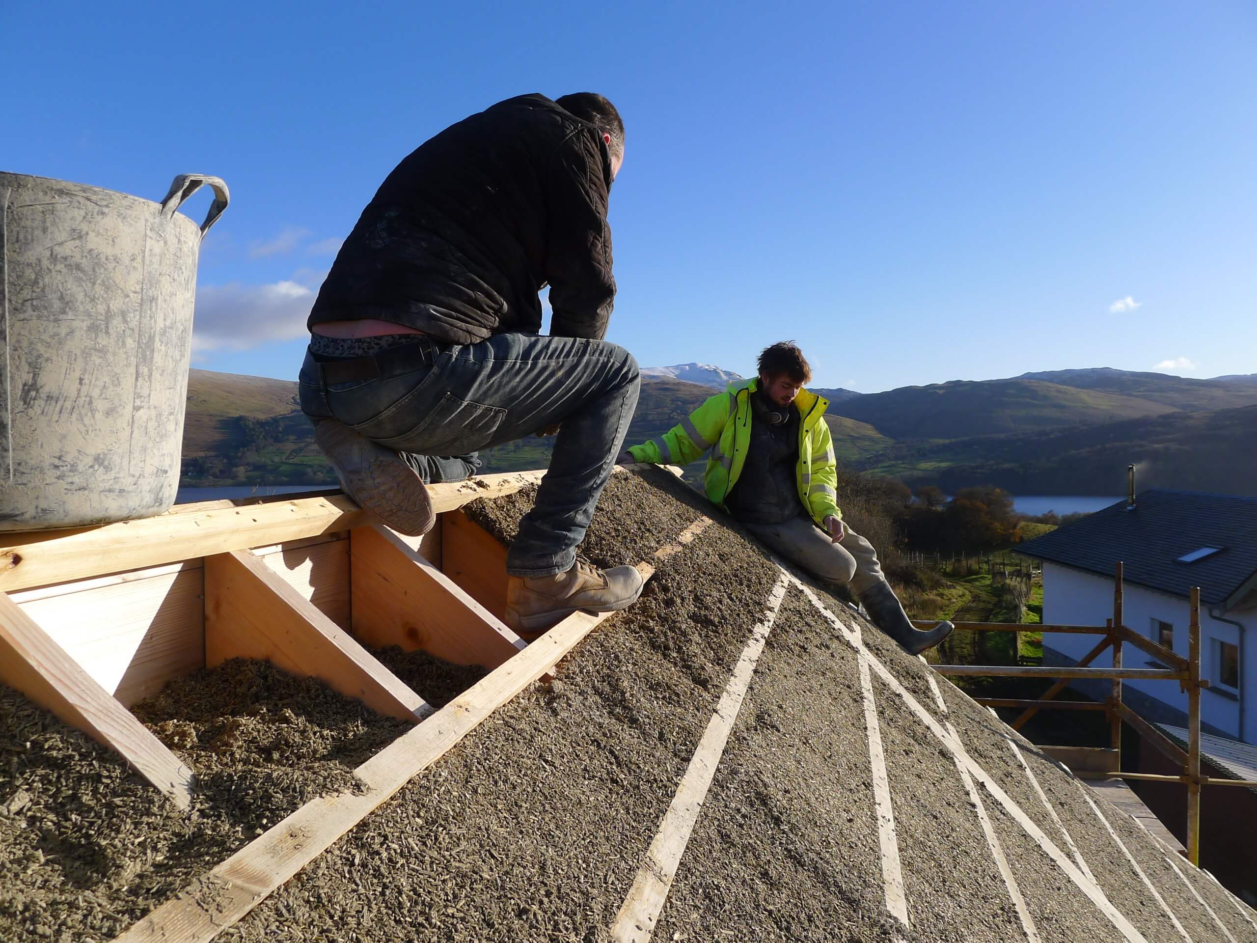 labourers installing hempcrete in a roof of a new build house in Perthshire