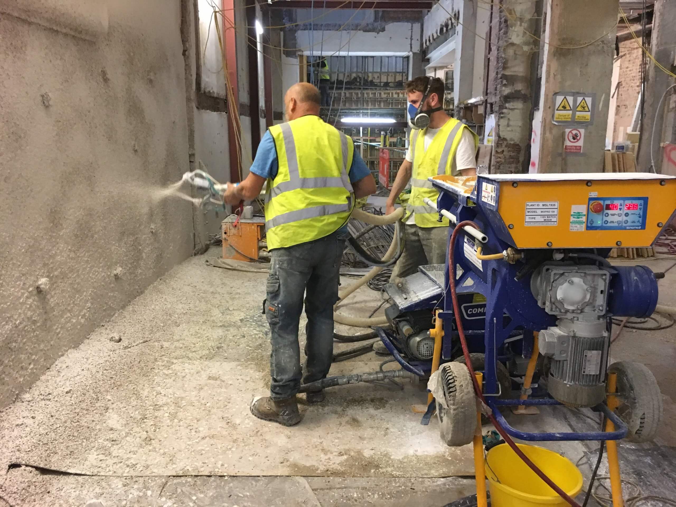 spraying hempcrete solid wall insulation onto a wall in London